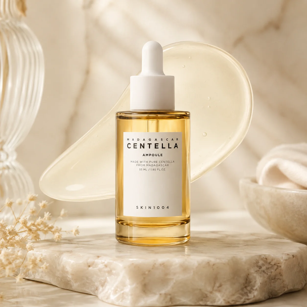 Madagascar Centella ampoule bottle on a marble surface, surrounded by a delicate natural aesthetic, with a textured gel background.